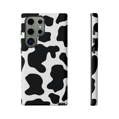 Black cow print phone case showing the back side with a protective cow print phone design in black and white colors