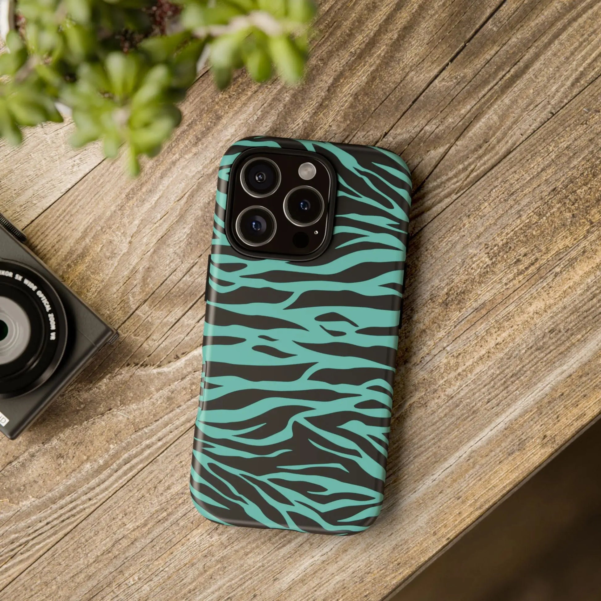 Teal and black zebra-striped phone case with sleek protective design featuring a wild tiger print pattern on the back