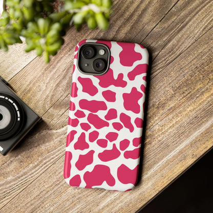 Back side of a vibrant pink cow print phone case cover with white spots and a smooth glossy finish for tough protection