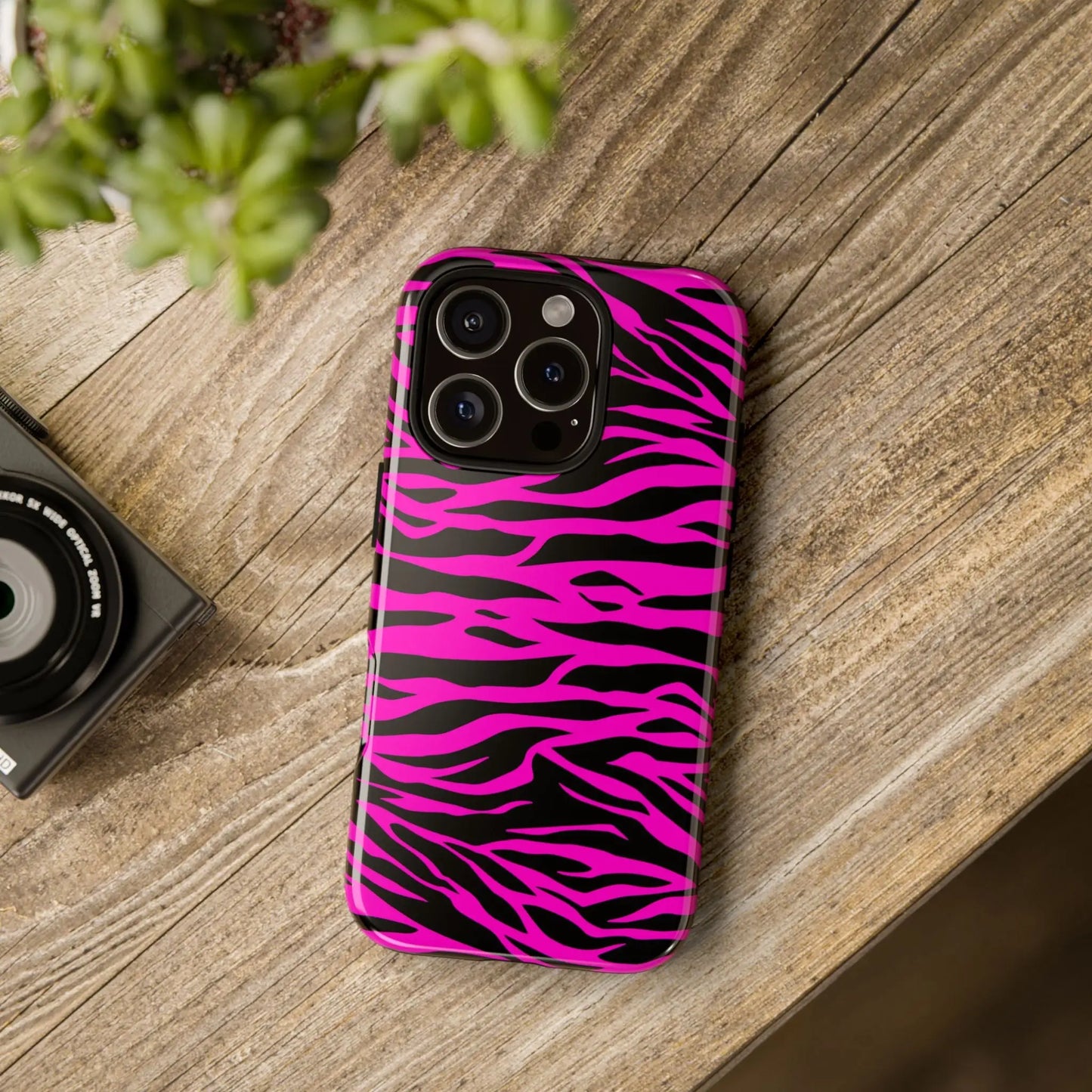 Back view of a vibrant pink and black zebra-striped tough phone case with a glossy finish for a tough phone