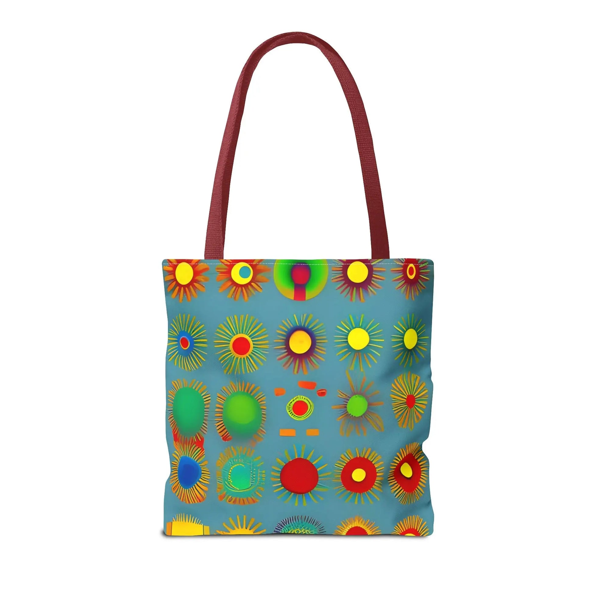 A vibrant blue sun pattern tote bag with bold colorful circular patterns and maroon handles for everyday use