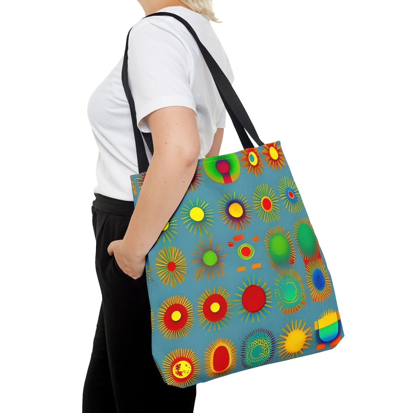 A vibrant blue sun pattern tote bag with colorful sunburst circles in red yellow green and rainbow hues
